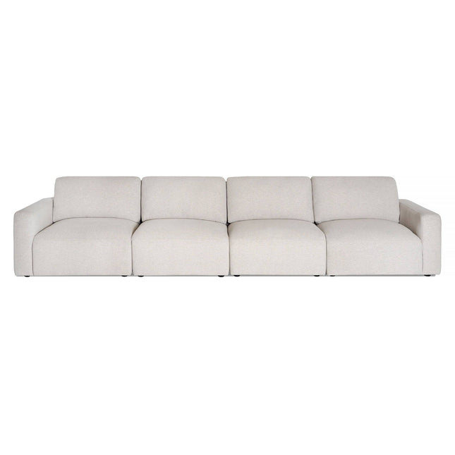 Introducing the Lugano Sectional: a light beige sofa with plush cushions, featuring four equal seats and low, wide armrests. Its minimalist design embodies Italian luxury for modern living spaces on a white backdrop.