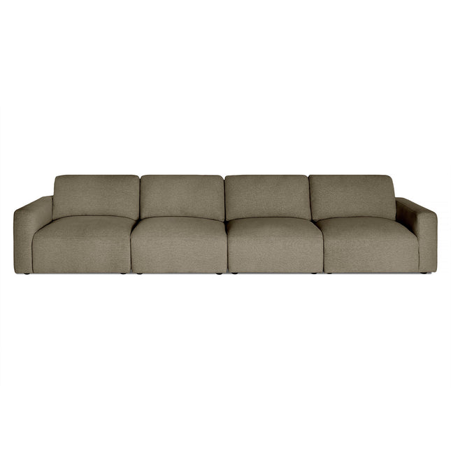 The Lugano is a large four-seater modular sofa with minimalist design and muted olive green upholstery. It has plush cushions, low armrests, and sleek lines, offering an Italian luxury touch ideal for contemporary living spaces.