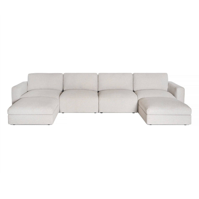Discover the Lugano Sectional, a symbol of Italian elegance with its sleek design and light gray finish. It offers plush cushions across four sections with extended chaises at both ends, all styled against a crisp white backdrop.
