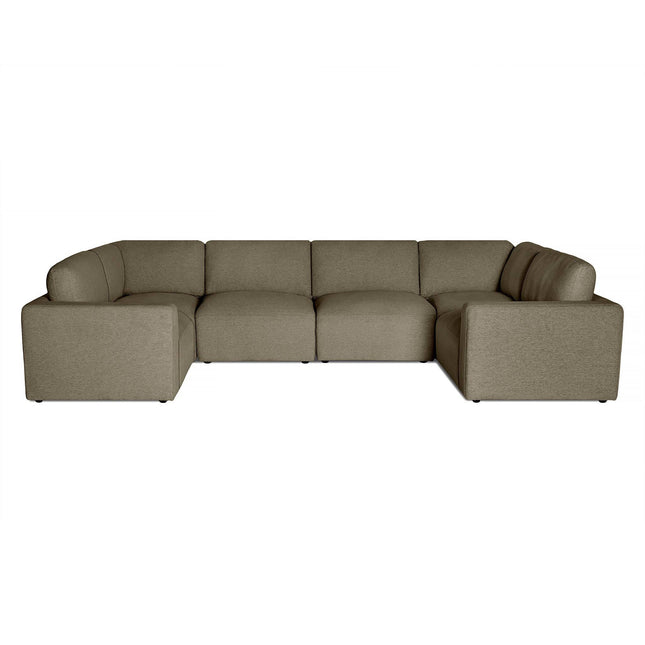 The Lugano Sectional is a luxurious Italian style sofa with a modern L-shape design in neutral gray fabric. It offers plush cushions and low-profile armrests for contemporary comfort, pictured against a white background.