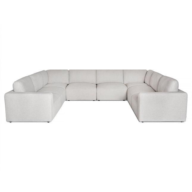 The Lugano is a luxurious white U-shaped sectional with plush cushions and wide armrests, featuring small black feet and an elegant design against a plain white background.