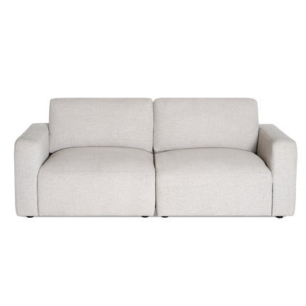 A front-facing view of the Lugano 2 Piece, a modern light gray two-seater sofa with broad armrests and minimalist design. It features upholstery that looks soft and slightly textured, sitting directly on the floor without visible legs.