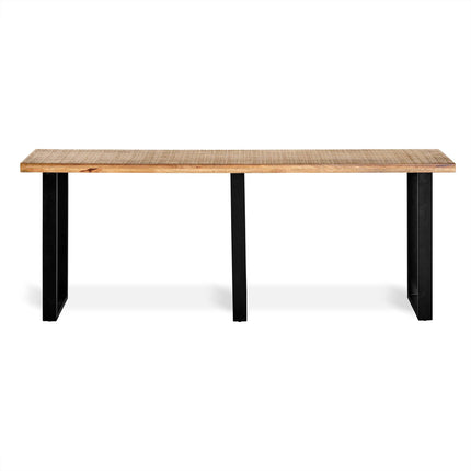 The Mango Console is a long, rectangular wooden table made from eco-friendly mango wood with a natural finish, featuring three black metal legs. Set against a white background, its perfect for dining rooms that want a modern and sustainable design.
