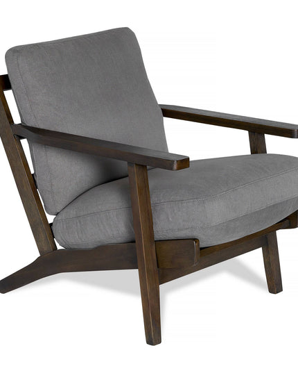 The Peyton Chair is a stylish wooden armchair with a dark brown frame and soft grey cushions on the seat and backrest. Featuring angled armrests and legs, it offers contemporary mid-century style and comfort to any space.