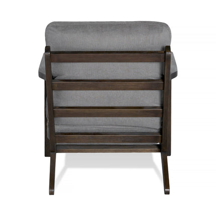 The Peyton Chair showcases a sleek rear view with dark brown slats and a cushioned backrest and seat upholstered in gray fabric. This mid-century style piece features a minimalist design with clean lines and a sturdy frame, perfectly blending elegance and comfort.