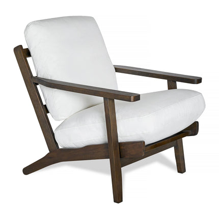 The Peyton Chair is a stylish wooden armchair with angular armrests and a dark brown frame, featuring a modern design with white cushioned back and seat for a contemporary, mid-century style look.