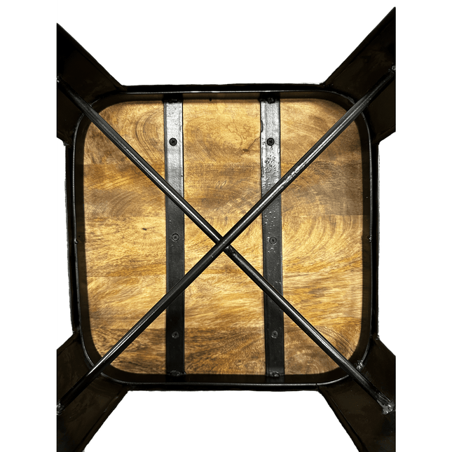 The wooden kitchen table, made from rich Mango wood with a square top, has two vertical metal bars and diagonal crossbars underneath for support. It pairs perfectly with the modern Mango Counter Stool.