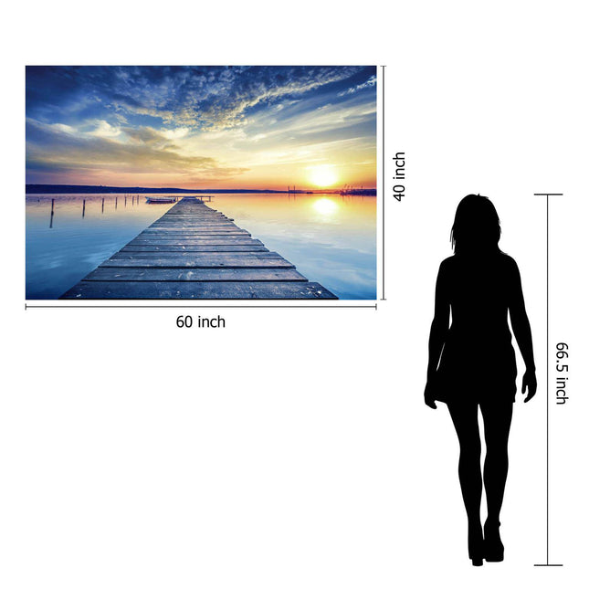 The Sunset Dock is a museum-quality tempered glass artwork featuring a 60x40 inch photo of a wooden pier extending into serene waters at sunset. A 66.5-inch silhouette provides scale, making it ideal for home or office decor.