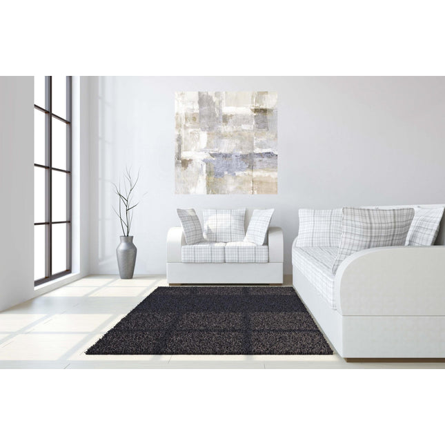 A minimalist room highlights the Neutral Sights white sofa with plaid cushions and a dark rug. A museum-quality abstract painting adorns the white wall, while a tall vase with branches in the corner and floor-to-ceiling windows flood the space with natural light for a lasting impression.