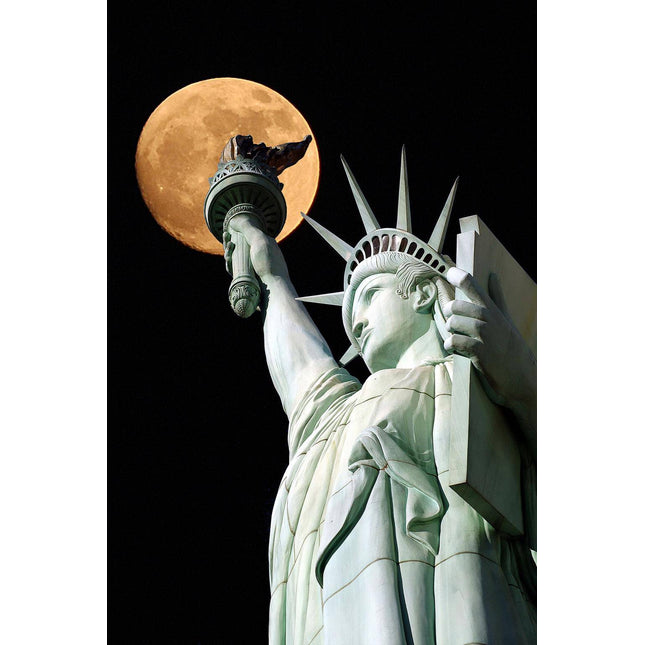 In Liberty Moonlight, the Statue of Liberty is portrayed from a low angle with a full moon in the background, resembling museum-quality art. Her torch and crown shine brilliantly against the night sky.