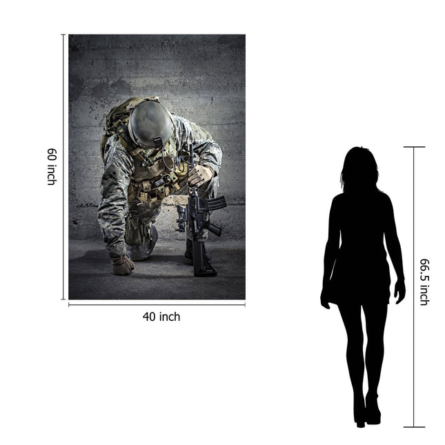 The Kneeling Soldier poster, measuring 60x40 inches, portrays a soldier in tactical gear and helmet crouched with a rifle. A 66.5-inch silhouette stands beside it for size comparison. This museum-quality artwork delivers a lasting impression with its striking detail.