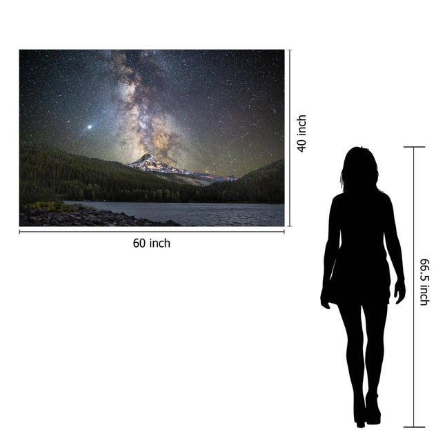 Beside a 66.5-inch silhouette stands the Starry Mountain, a 60x40 inch museum-quality artwork of the Milky Way over a forest and mountain, protected by tempered glass, enhancing the photos stunning grandeur.