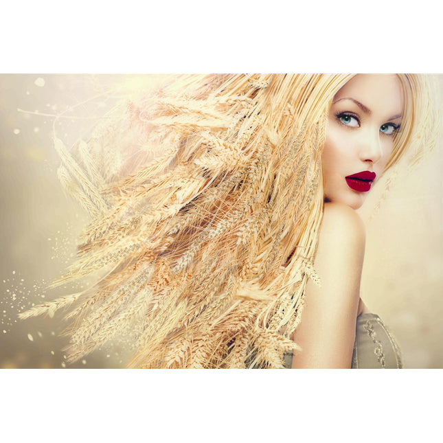 A woman with long golden hair blending into wheat stalks gazes over her shoulder in Wheat Head. Her bright red lips and piercing eyes captivate against a soft yellow backdrop on this hand-painted canvas, exuding a dreamy, ethereal quality.