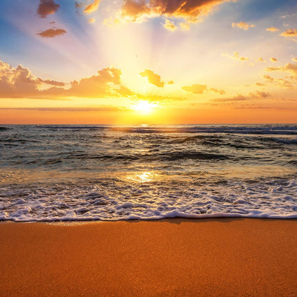 The Sunset Beach product features a vibrant ocean sunset with golden light streaming through clouds. The suns reflection on the water and gentle waves on the sandy shore create a serene ambiance, ideal for museum-quality artwork in your home or office.