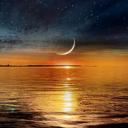 A museum-quality artwork, New Moon Horizon, features a crescent moon and stars lighting up the night sky over a calm ocean. The orange glow of a setting sun reflects on the waters surface, with a distant landmass in view—ideal for any home or office.