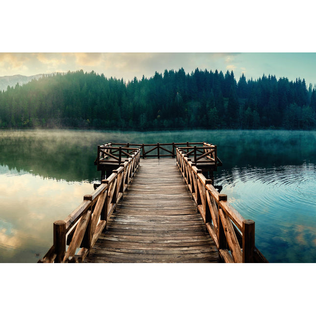 Dock View depicts a serene wooden pier extending over a misty lake to a square platform, framed by dense pine forests under soft dawn or dusk light, offering museum-quality artwork ideal for any home or office setting.