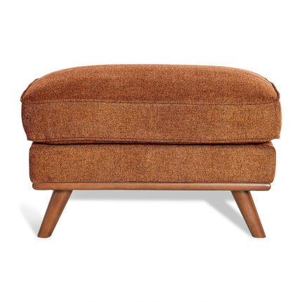 The Maddox Ottoman is a mid-century modern piece with an orange upholstered cushion and wooden legs. Its textured fabric enhances the elegant design, while slightly angled legs add to its retro aesthetic, making it ideal for any living space.