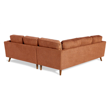 The Maddox sectional sofa is ideal for any living room, featuring a modern mid-century design with clean lines, rust-colored upholstery, and wooden legs. Its minimalist look includes multiple cushions resting against a simple white backdrop.