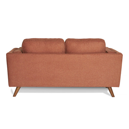 The image shows the Maddox Loveseat, a mid-century modern piece with brown upholstery and two cushions. It has a simple rectangular design and stands on four angled wooden legs, showcasing its durable construction.