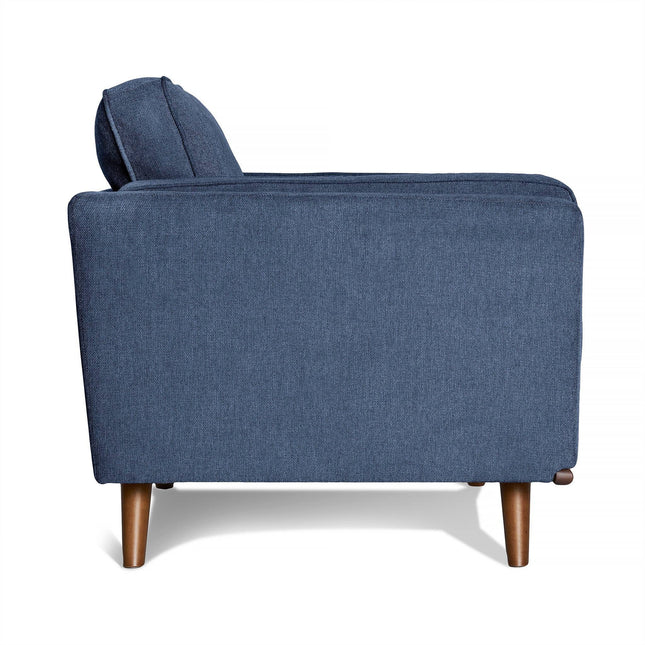 Side view of the Maddox Chair, a modern blue fabric armchair featuring a high backrest, rounded wooden legs, and a minimalist design reminiscent of mid-century modern style with clean lines for comfort.