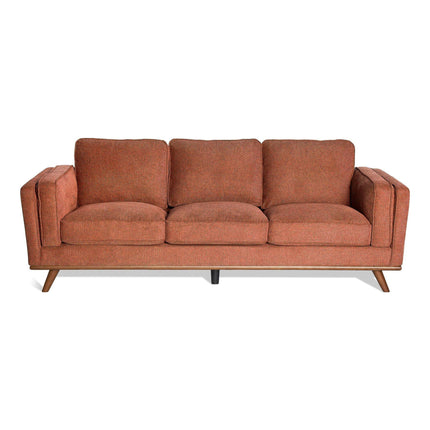 The Maddox Sofa Set features mid-century modern design with plush, loose cushions in warm terracotta. It includes angled wooden legs and sturdy armrests, perfect for a sleek, minimalist look in any contemporary space.