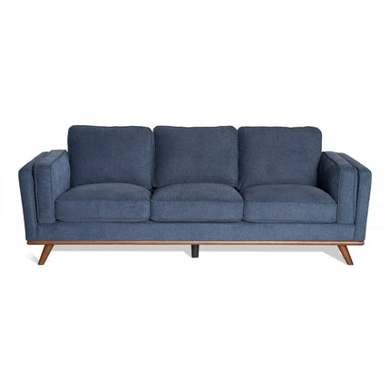 The Maddox Sofa is a blue three-seater with a mid-century modern design, featuring plush back cushions, slightly angled wooden legs, and a wooden frame base. Its clean, minimalist appearance makes it ideal for contemporary living spaces.