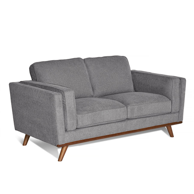 The Maddox Loveseat boasts a mid-century modern look with minimalist design, straight armrests, and outward-angled wooden legs. Its durable build, textured fabric upholstery, and cushioned seats and backrests ensure lasting comfort and a cozy feel.