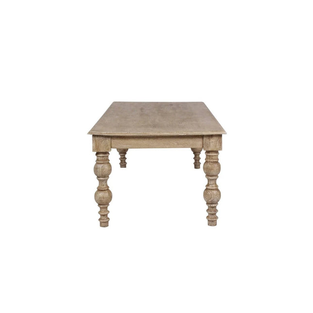 The French Country Coffee Table, crafted from solid mango wood with a rustic finish, features four intricately carved legs. Its simple, classic design beautifully showcases the distressed natural grain of the wood.