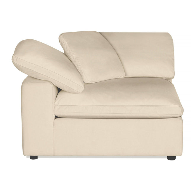 The Peyton Corner is a high-quality beige sectional chair with two cushions, a wide seat, and a slanted backrest. Its minimalist design with black feet complements modern living spaces, offering an irresistibly soft and comfortable feel.