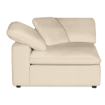 The Peyton Corner is a high-quality beige sectional chair with two cushions, a wide seat, and a slanted backrest. Its minimalist design with black feet complements modern living spaces, offering an irresistibly soft and comfortable feel.
