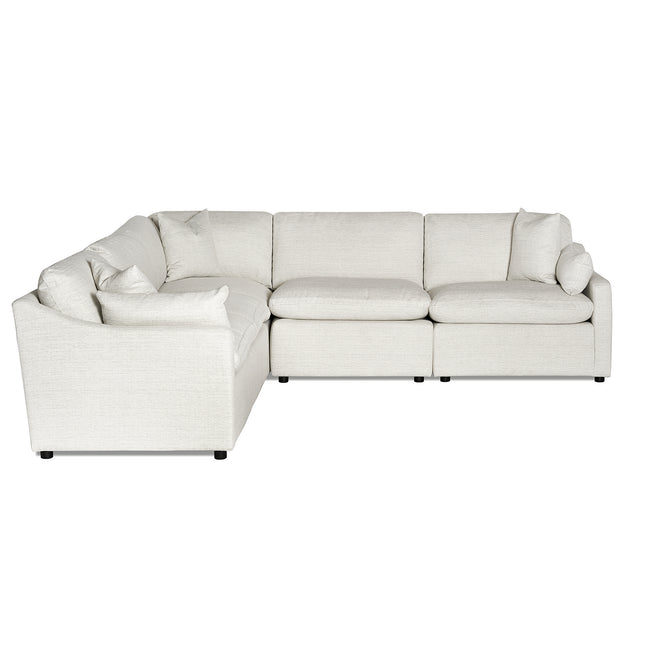 A light gray L-shaped sectional sofa with plush cushions and a smooth fabric finish sits on small black legs, offering a minimalist design ideal for contemporary spaces. Free fabric swatches available.