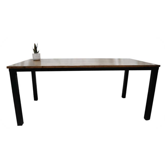 The Acacia Loft Desk, made from solid acacia wood, boasts a minimalist rectangular design with black legs and a white backdrop. Ideal for a chic home office, it comes with a small potted succulent in the left corner to add greenery.