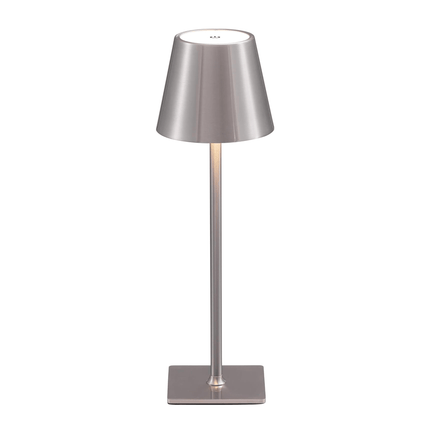 The Aura Lamp is a modern, sleek table lamp with a metallic finish. It features a cone-shaped shade, slender stem, and square base in uniform silver. Its minimalist and portable design makes it ideal for any contemporary space.