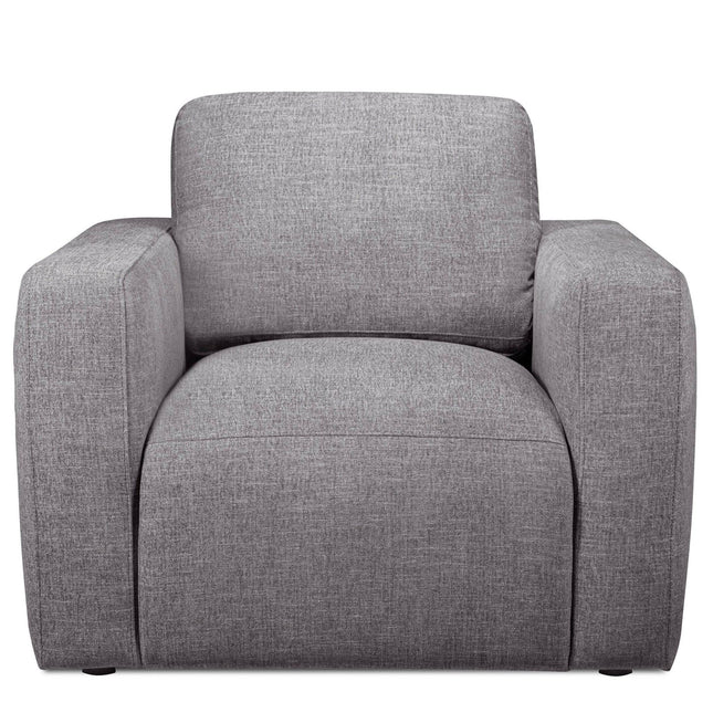 The Lugano Chair is a modern, gray upholstered armchair made from premium materials. It features wide armrests, a cushioned backrest, and a minimalist boxy design that reflects Italian luxury, making it ideal for contemporary interiors as part of the Lugano Sofa Set.