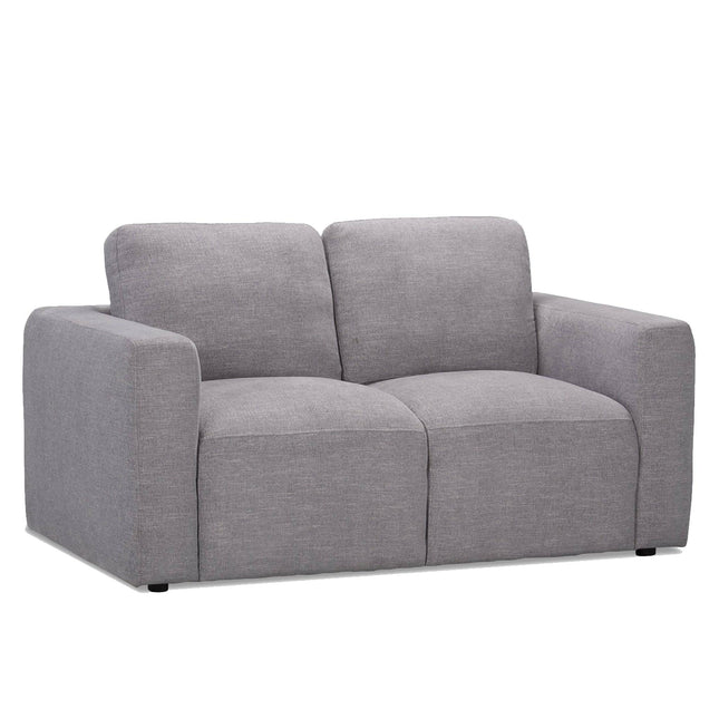 The Lugano Loveseat is a modern two-seater sofa with a minimalist design. Upholstered in light gray fabric and crafted from premium materials, it offers plush cushioning, wide armrests, and a smooth backrest for an Italian luxury seating experience.