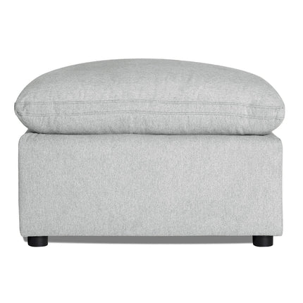 Discover the My Cloud 30 Ottoman, featuring light gray upholstery, a rectangular base, and cushioned top. It rests on four small round black legs, offering style and comfort for any space with customizable options.