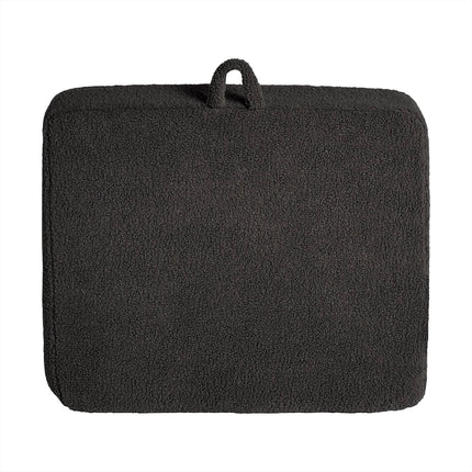 A rectangular, textured dark gray cushion with rounded edges and top loop for carrying or hanging is crafted from soft Sherpa fabric, boasting a fleece-like surface for added comfort. It perfectly complements the My Cloud Kidz Chair to create a cozy and inviting space.