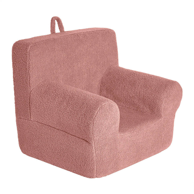 Introducing the My Cloud Kidz Chair: a cozy, plush pink armchair for kids, made with soft Sherpa fabric. It features a simple design with a rounded back, armrests, and a convenient fabric loop on the back for easy carrying—perfect for young adventurers on the move.