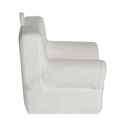 Side view of the My Cloud Kidz Chair, a plush white armchair with Sherpa fabric. Its soft, fluffy texture and boxy design, featuring a tall backrest and solid armrests, make it ideal for crafting a cozy, modern home vibe.
