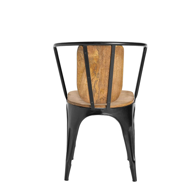 The Mango Barrel Chair features a curved black metal frame with a mango wood seat and backrest, showcasing an industrial design that combines sustainable handcrafted textures of metal and wood, especially striking when viewed from the back.