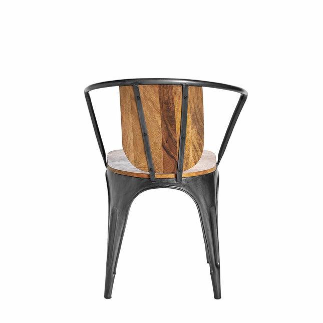 The Mango Barrel Chair features a round metal frame, wooden backrest, and metal seat. Blending industrial and natural elements with black metal and a rustic wood finish, this sustainably crafted dining chair resembles mango wood chairs from the back.