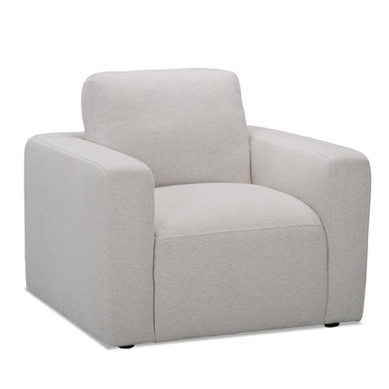 The Lugano Chair is a modern, light gray armchair made from premium materials. It features a plush cushion and broad armrests with an Italian luxury-inspired square design, complemented by small, unobtrusive feet, making it ideal for a contemporary living room.