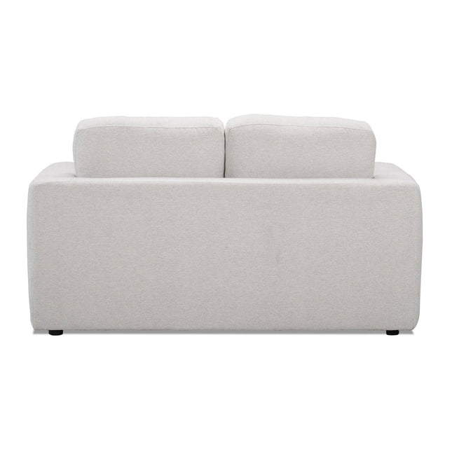The Lugano Loveseat is a modern piece crafted from premium materials, featuring light gray fabric and two cushioned backrests. Its simple, boxy design exudes Italian luxury, elegantly positioned on a white background.