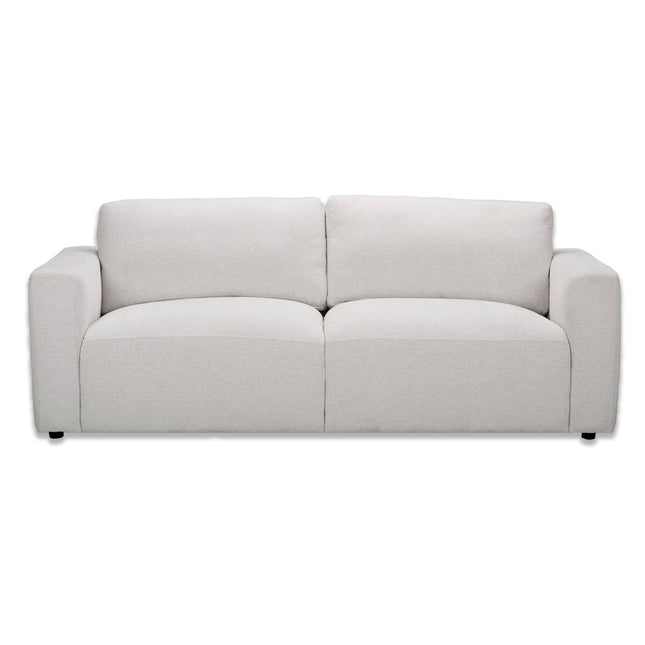 The Lugano Sofa showcases Italian luxury with its minimalist light gray design, featuring premium materials, two large seat cushions, two back cushions, wide armrests, and sleek black legs for a smooth fabric finish.