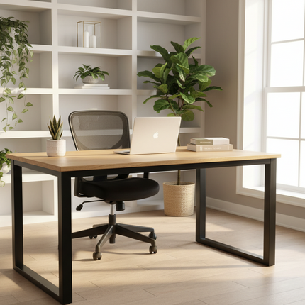 Acacia Loft Desk staged in a bright modern home office with a chair, laptop and plant-filled shelving