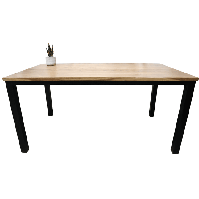 The Acacia Loft Desk, made from solid acacia wood with sleek black metal legs, stands against a white background. A small potted cactus in the top left corner adds greenery, creating a perfect minimalist home office setup.