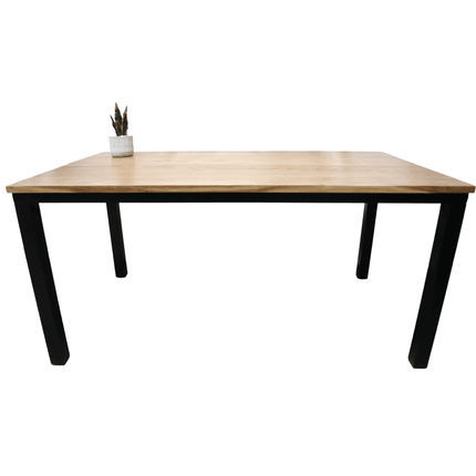 The Acacia Loft Desk, made from solid acacia wood with sleek black metal legs, stands against a white background. A small potted cactus in the top left corner adds greenery, creating a perfect minimalist home office setup.
