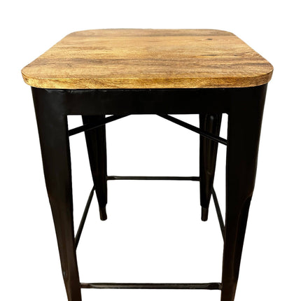 The Mango Counter Stool has a wooden top made from mango wood, sturdy black metal legs, and a crossbar for support, effortlessly combining simplicity with industrial design for your kitchen.