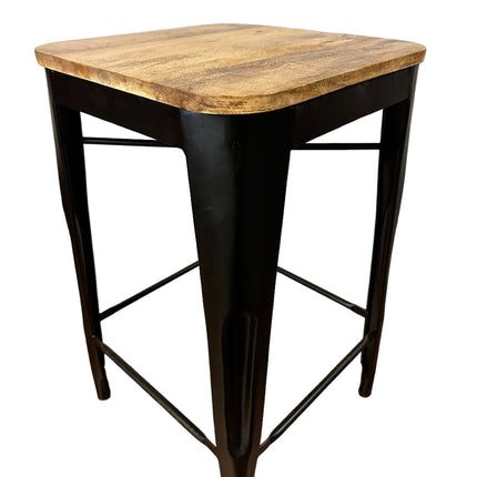 The Mango Counter Stool is a small, square stool with a sleek mango wood top and black metal legs, boasting a simple and modern design that blends clean lines with a minimalist aesthetic—ideal for kitchen counter seating.
