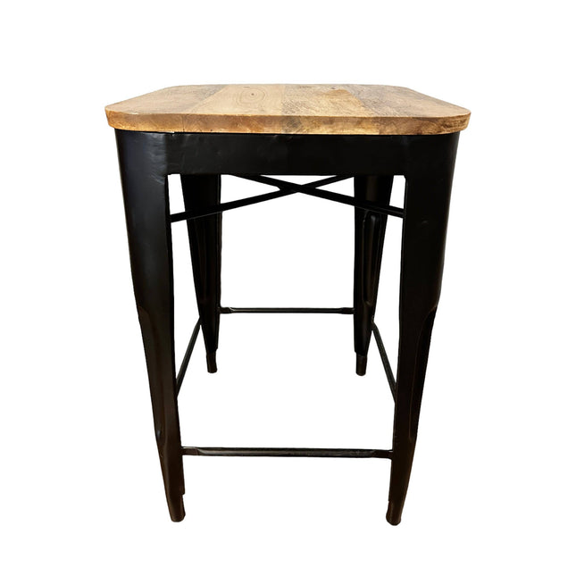 The Mango Counter Stool features a square mango wood seat and black metal legs with a crossbar support for stability, blending rustic and modern elements. Perfect as a kitchen staple, it suits various interior styles with its industrial feel.
